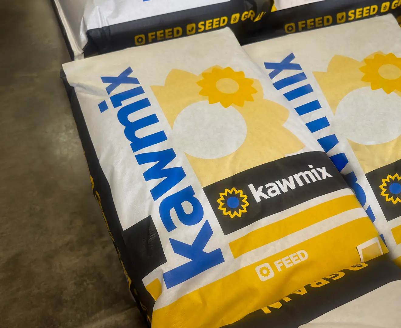Kawmix livestock feed bags stacked in a warehouse at Valley Feed & Supply.