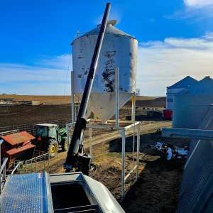 Filling an overhead feed bin on a farm