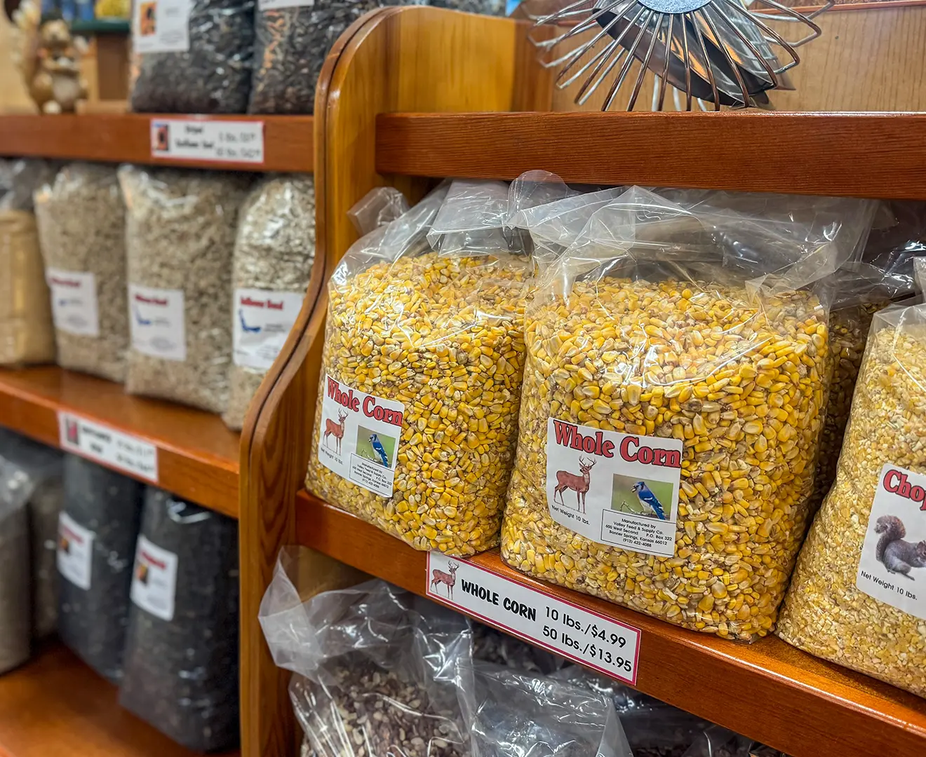 Feed shelf inside Valley Feed & Supply store featuring whole corn for livestock feed.